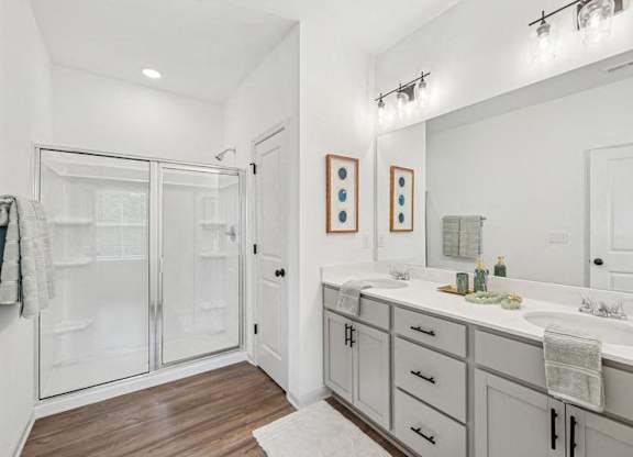Primary bathroom with double vanity, and walk-in shower.