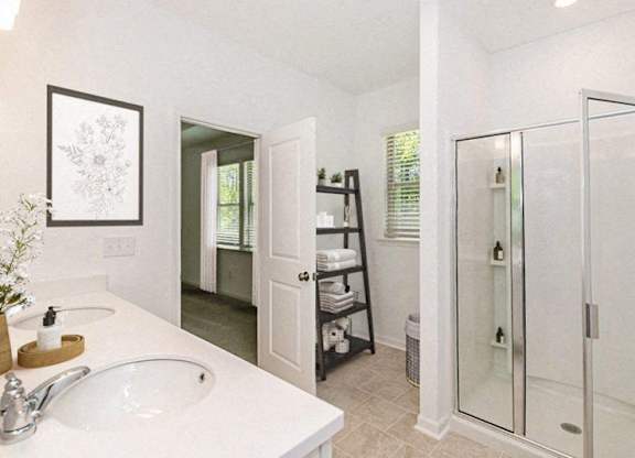 Bathroom with double vanity, and walk-in shower.