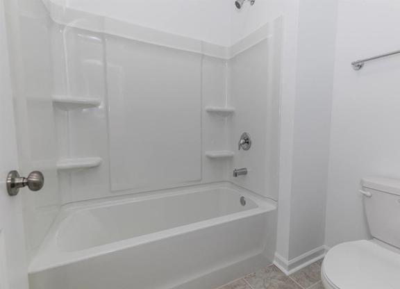 Secondary suite bathroom with a tub and shower combination