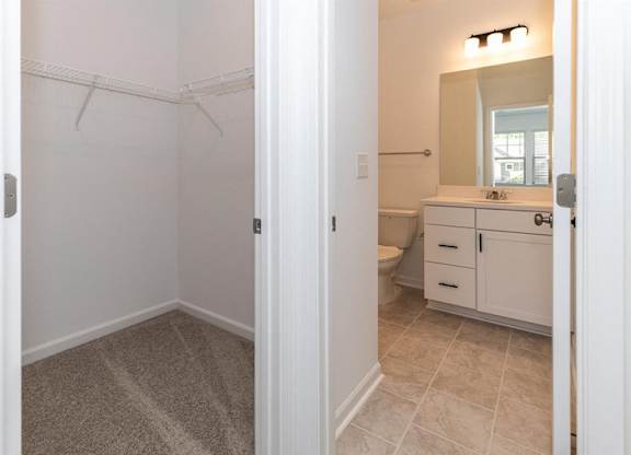 View of the full walk-in closet adjacent to the bathroom.