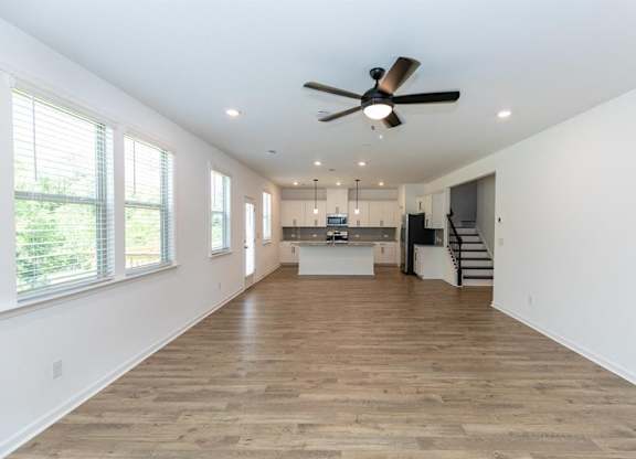 Spacious kitchen offering an elegant path to the stairwell.