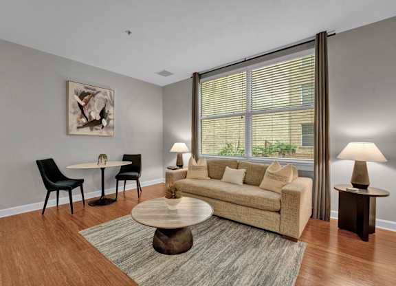 A living room with a couch, chairs, and a coffee table.