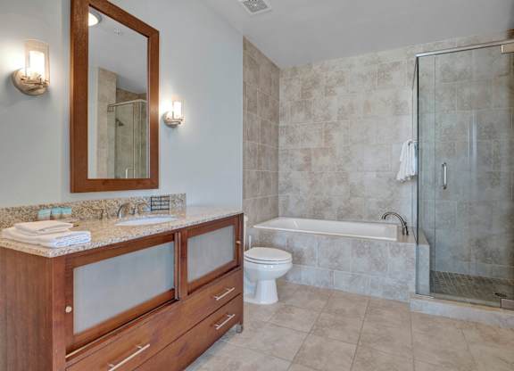 A bathroom with a toilet, sink, and shower.