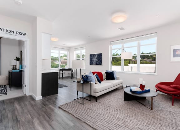 Model apartment with open concept floor plan, large windows, carpet