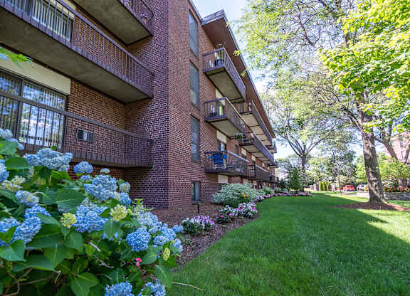 Quincy Commons apartments with beautiful landscaping and flowers along each building