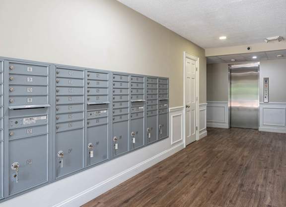 A row of mailboxes are lined up on a wall.