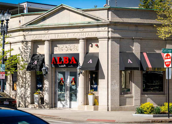 A building with a red sign that says Alba.