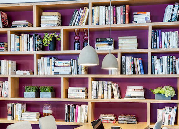 A room with a desk, chairs and bookshelves, library space at 3200 Washington