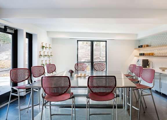 A kitchen with a table and chairs.