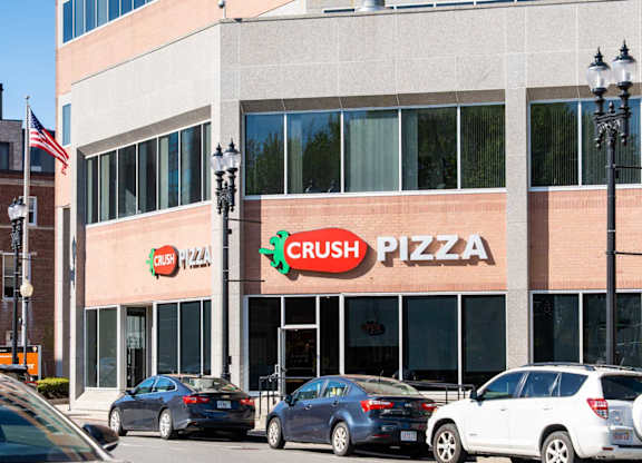 A Crush Pizza restaurant with cars parked in front.