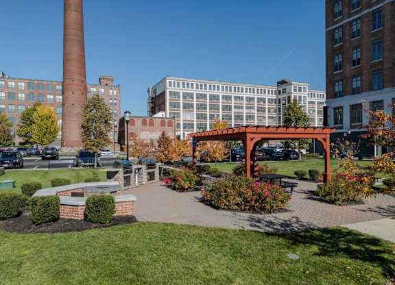 The courtyard with fire pit, grills, pergola next to buildings 240 and 242