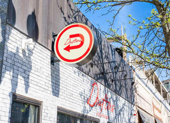 Drifters restuarant sign is on a building.
