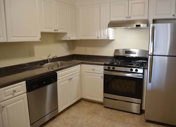 Quincy Commons kitchen with stainless steel appliances and bright white finishes