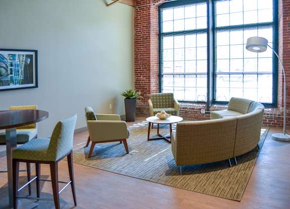 Living room with two chairs and couch at Mass Mills Apartments Lowell