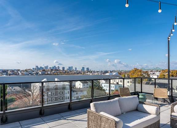 The roof deck/uptown perch at DUO with sweeping views of Chelsea MA and Boston in the background