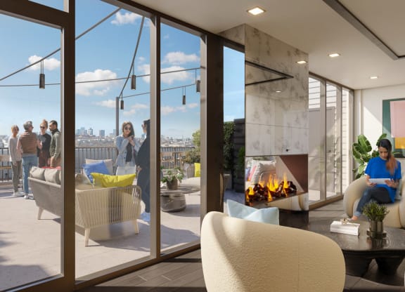 An inviting sky lounge with expansive floor-to-ceiling windows offering breathtaking views of the city skyline. The lounge is furnished with plush armchairs, a modern fireplace, and stylish decor. Residents are seen both inside and on the connected outdoor terrace, enjoying the luxurious and cozy environment designed for relaxation and social interaction.