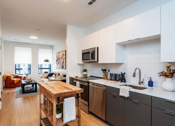 a kitchen with stainless steel appliances and a wooden table