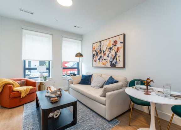 a living room with a couch and a table and a window