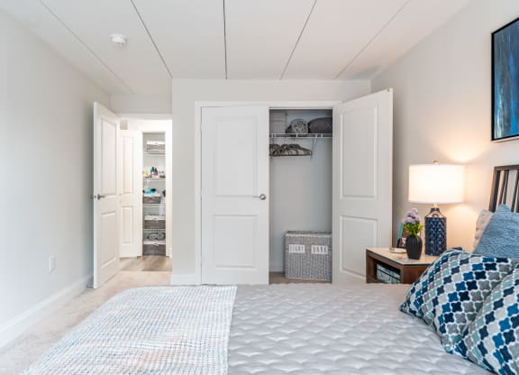 a bedroom with a large bed and two closets
