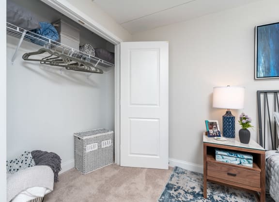 a bedroom with a closet and a desk with a lamp