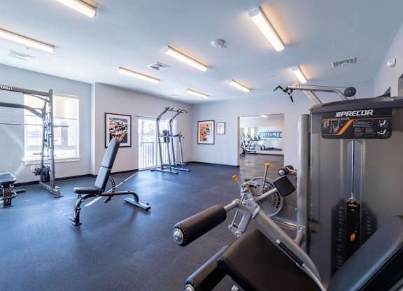 A gym with a variety of equipment including a leg press machine.