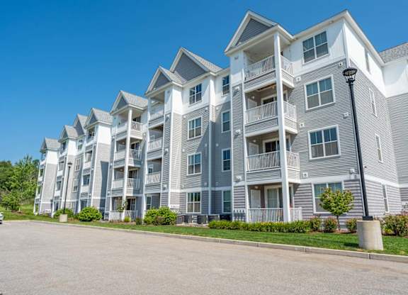 a row of apartment buildings with a street in front of them