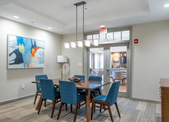 a dining room with blue chairs and a wooden table