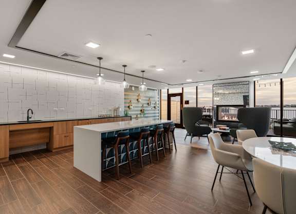 A modern kitchen with a long island and bar stools.