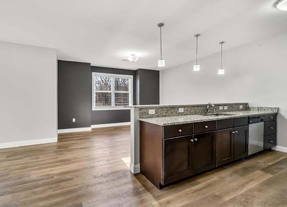 Ashland woods apartment large floor plan and kitchen including granite, stainless steel appliances and high quality finishes with accent wall