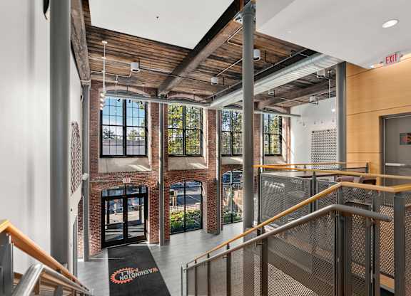A view of a staircase with a black mat on the floor that says "COMMUNITY".
