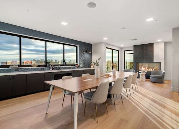 A modern kitchen with a dining table and chairs.