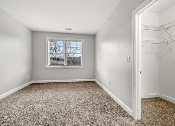 Ashland woods apartments with walk in closet and bedroom with plush carpeting