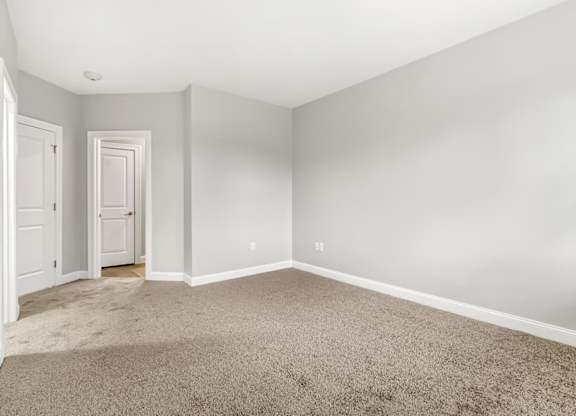 Ashland woods apartments in MA bedroom with carpet flooring and large windows