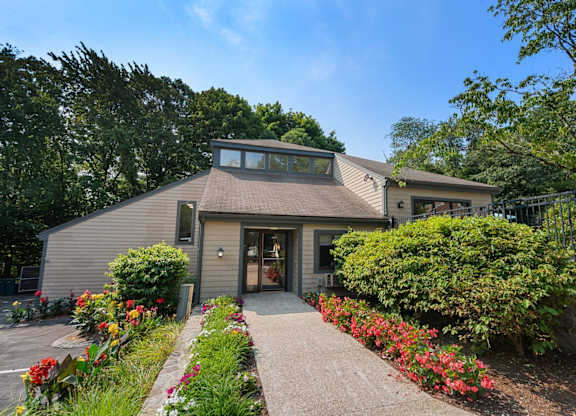 A house with a grey roof and a brown front door.