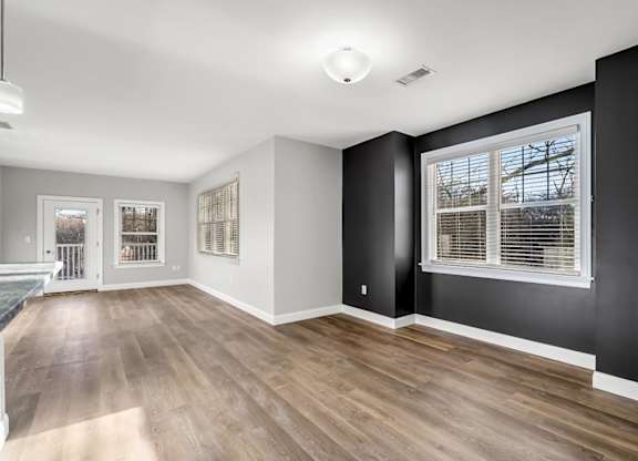 Ashland woods apartment large floor plan, accent wall, and large open windows.