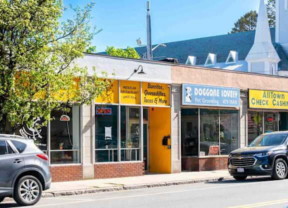 A yellow and white building with a sign that says