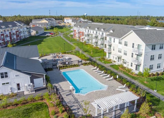 Redbrook in Plymouth pool, leasing center and grills with firepit.