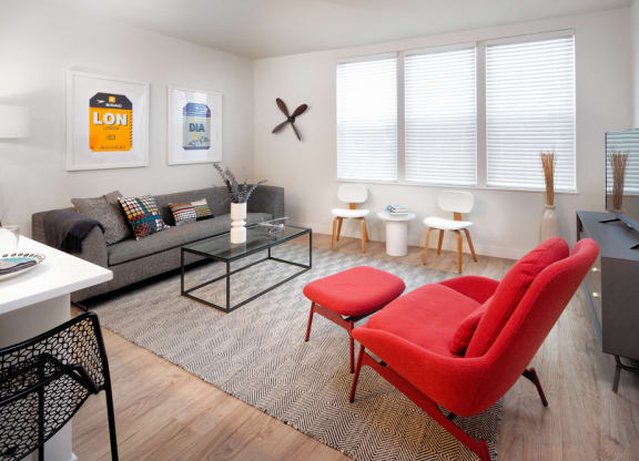 The mastlight model apartment common space with large couch windows and seating