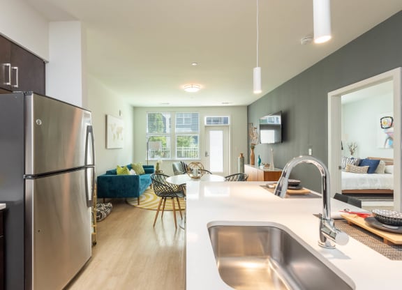 kitchen and living room at the district flats apartments in lenexa, ks