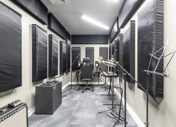 a recording studio with a variety of instruments and microphones