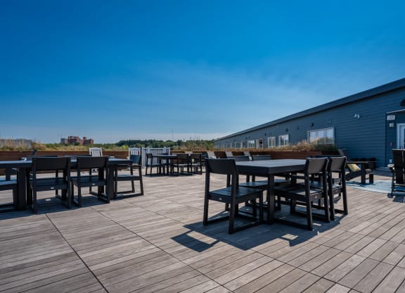 a patio with tables and chairs on a roof