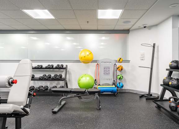 a fitness room with weights and other exercise equipment