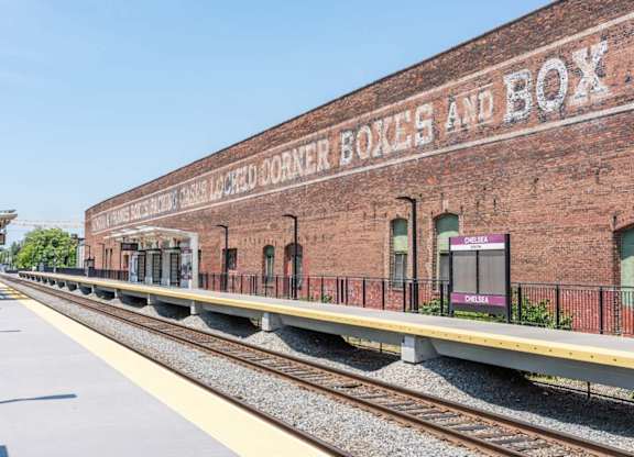 A train station with a sign that says "Boxcar Box and Box".
