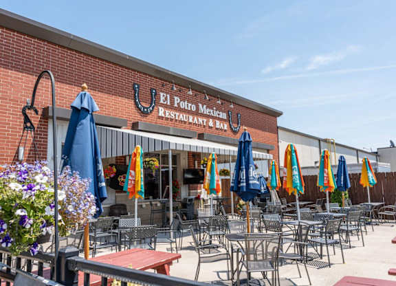 A Mexican restaurant and day club with tables and chairs set up outside.