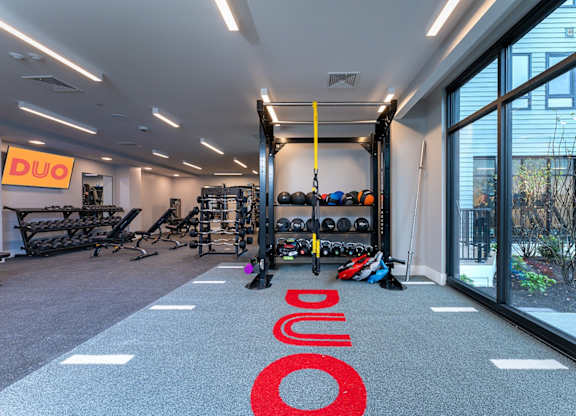 A gym with a red carpet that says DUO.