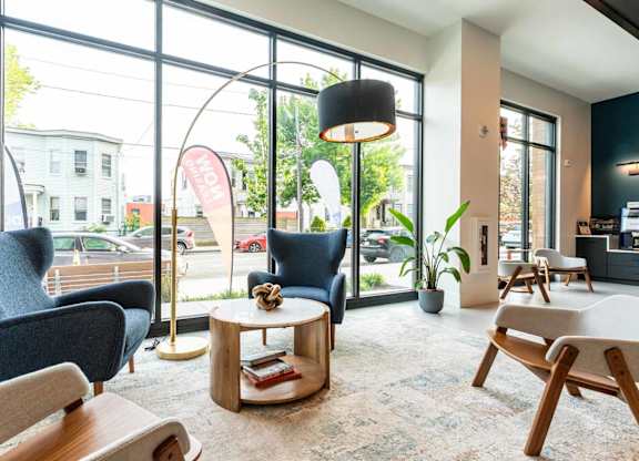 A waiting area with comfortable seating and a view of the street outside.