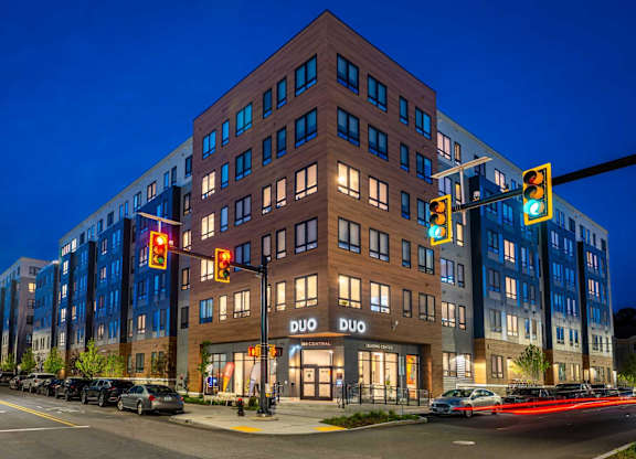 A Duo hotel is lit up at night.