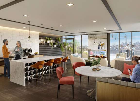 A modern kitchen and dining area with people socializing.