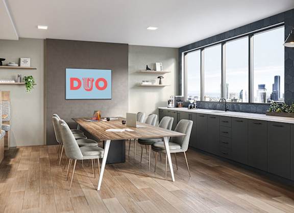 A modern kitchen with a dining table and chairs.
