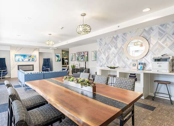 The community lounge at Parkside Commons with a long wooden table and chairs